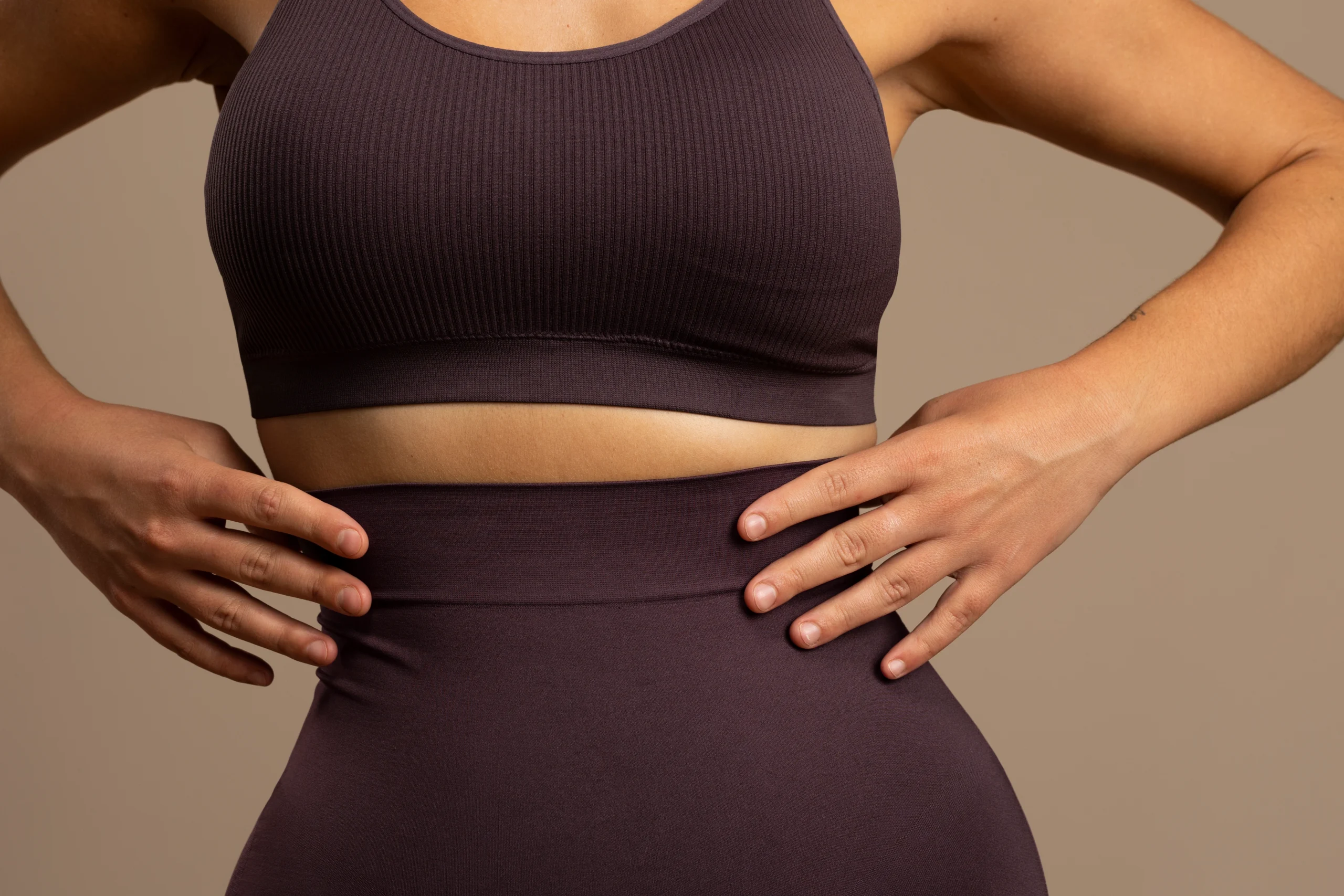 Woman measuring waist after successful 360 body contouring in Dubai