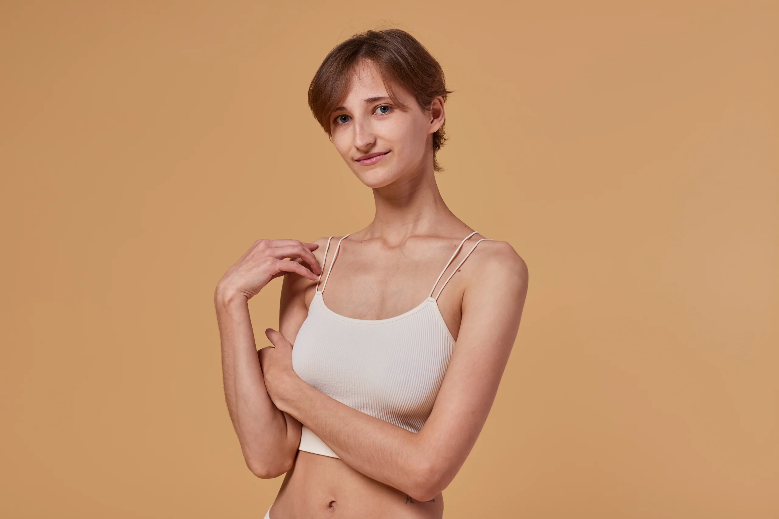 Woman wearing compression bra during breast augmentation recovery in Dubai